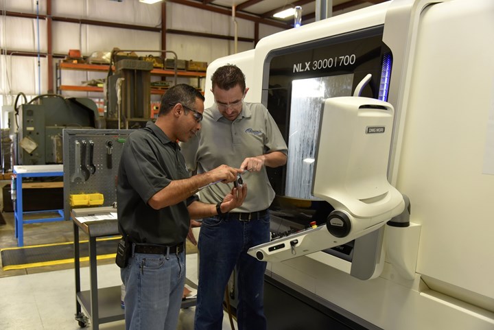 Anthony Machine’s operations manager Mohsen Saleh looks at a workpiece with CNC machinist setter Mark Garland